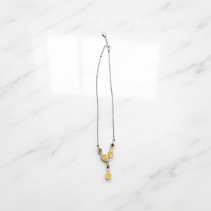 This stylish Liz & Co. necklace features a silver-tone chain with several yellow
